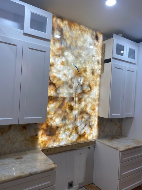 Backlit full-height quartzite backsplash