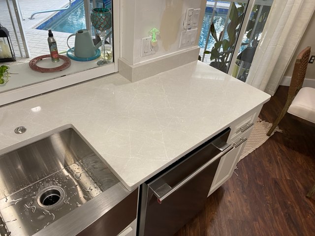 Countertop beside window and dishwasher